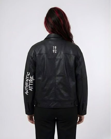 Person wearing a black leather jacket with text on the back against a white background