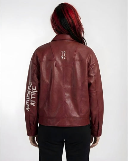Red leather jacket with '1992' on the back and 'Authentic Attire' on the sleeve, worn by a person.