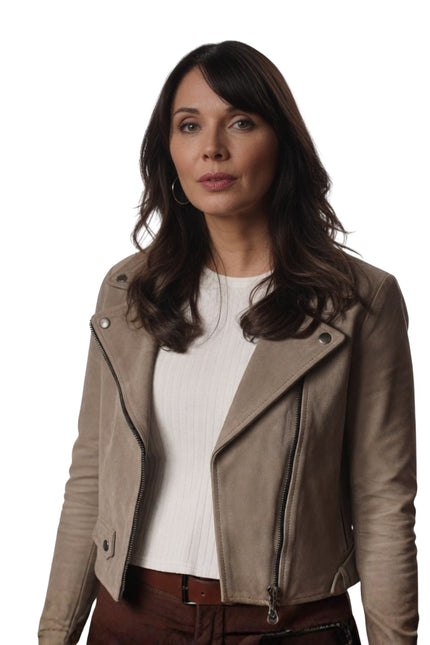 Woman wearing a beige leather jacket on a white background