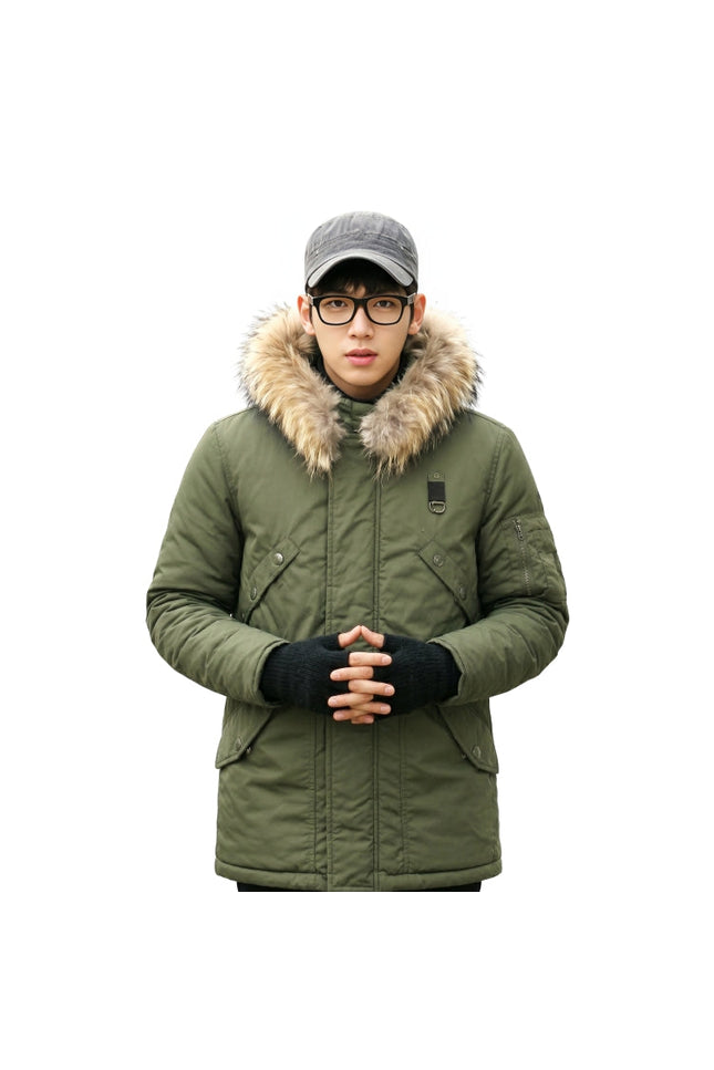 Person wearing a green winter coat with fur hood on a white background