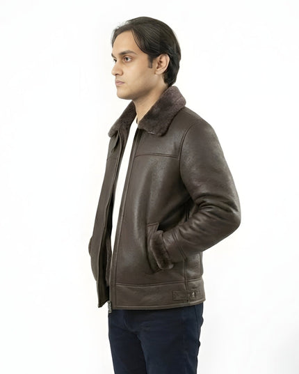 Man wearing a brown leather jacket with fur collar on a white background
