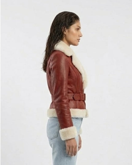 Woman wearing a red leather jacket with white fur trim on a white background