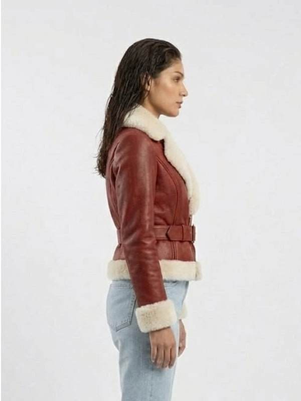 Woman wearing a red leather jacket with white fur trim on a white background