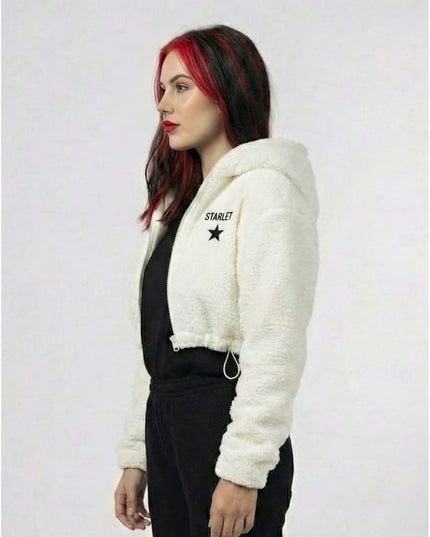 Woman wearing a white fluffy jacket with 'Starlet' branding on a plain background