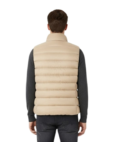 Man wearing a beige puffer vest on a white background