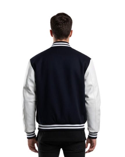 Person wearing a navy and white varsity jacket on a white background