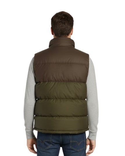 Man wearing a two-tone puffer vest with a white background