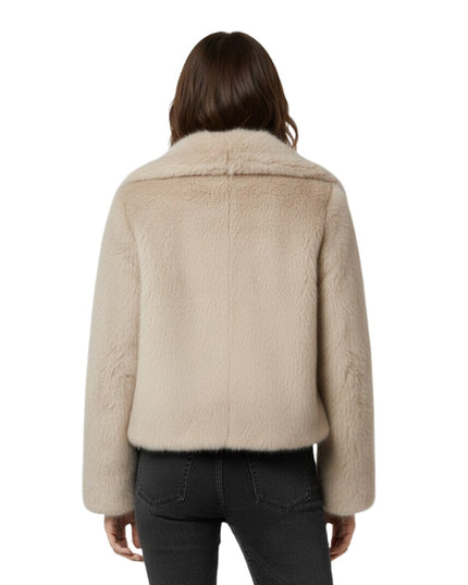Beige shearling jacket worn by a person on a white background