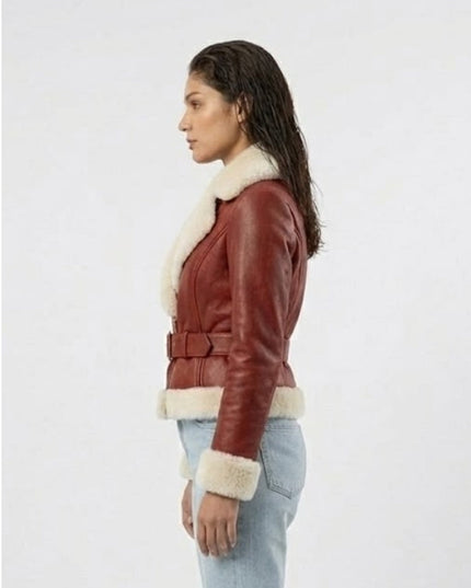 Woman wearing a brown leather jacket with white fur trim on a white background