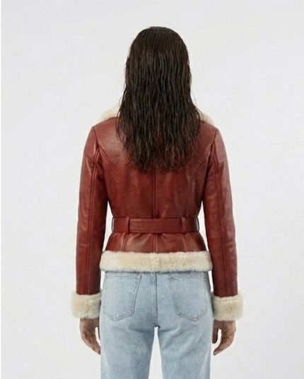 Person wearing a red leather jacket with fur trim on a white background