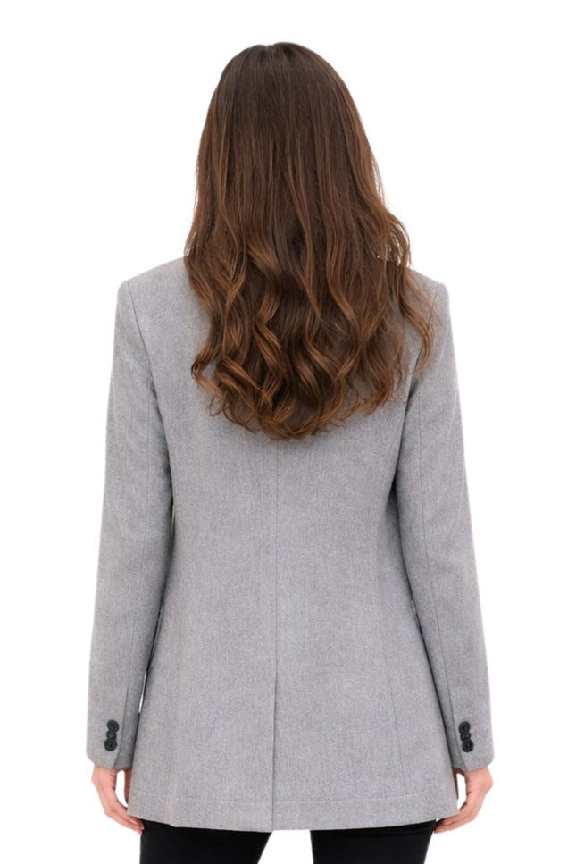 Woman wearing a gray coat from behind on a white background
