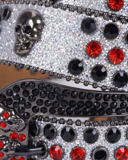 Decorative item with black and red gemstones on a reflective surface