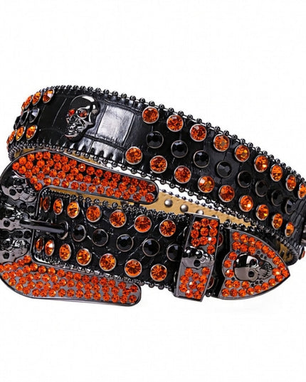 Black belt with orange rhinestones and skull designs on a white background