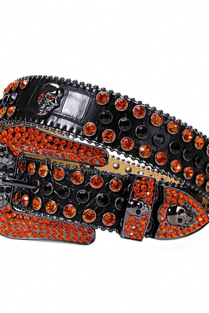 Black belt with orange rhinestones and skull designs on a white background