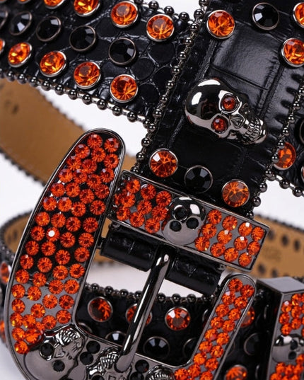 Black belt with orange rhinestone buckle on a white background