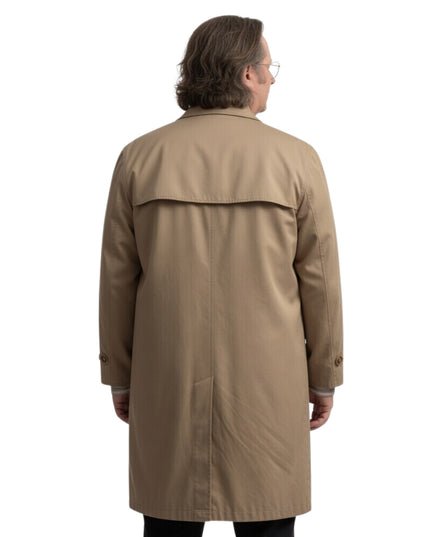 Man wearing a beige trench coat on a white background