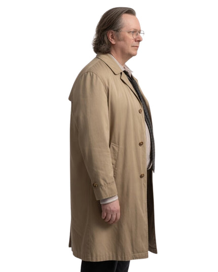 Man wearing a beige trench coat on a white background