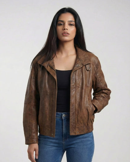 Woman wearing a brown leather jacket and blue jeans on a white background