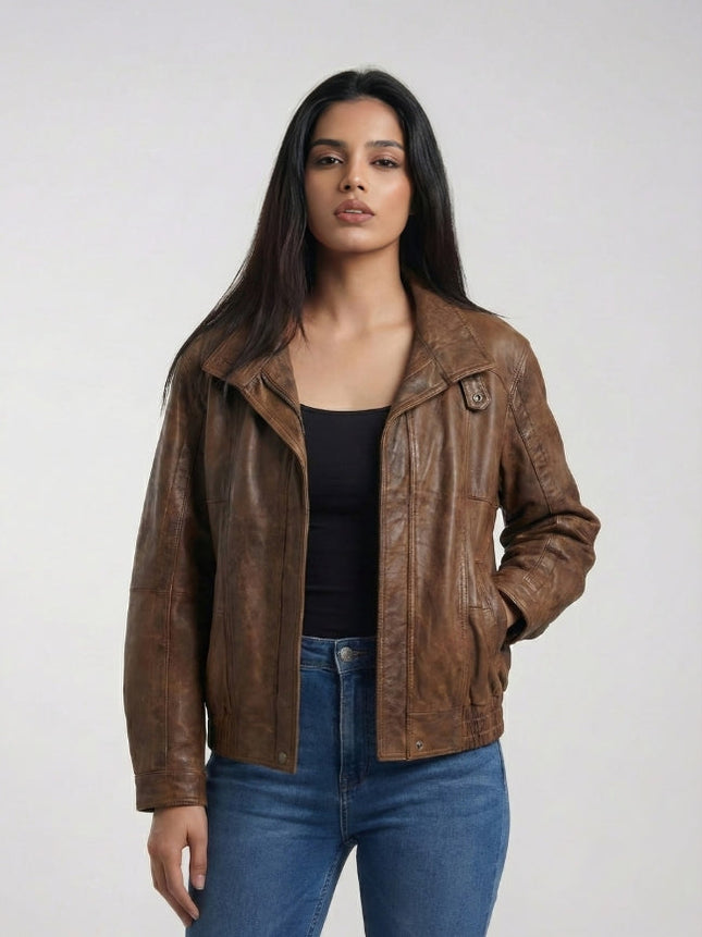 Woman wearing a brown leather jacket and blue jeans on a white background