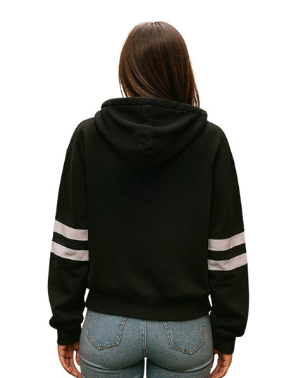 Person wearing a black hoodie with white stripes on sleeves against a white background