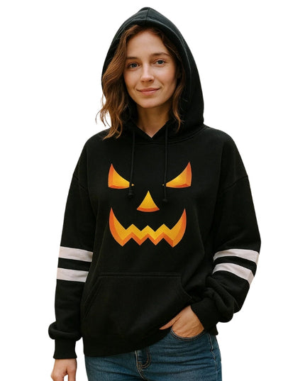 Person wearing a black hoodie with a jack-o'-lantern face design on a white background