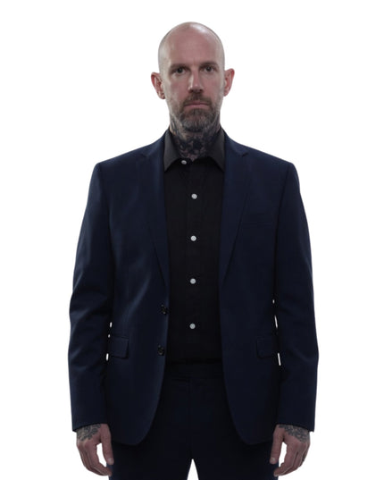 Man wearing a dark suit and shirt on a white background