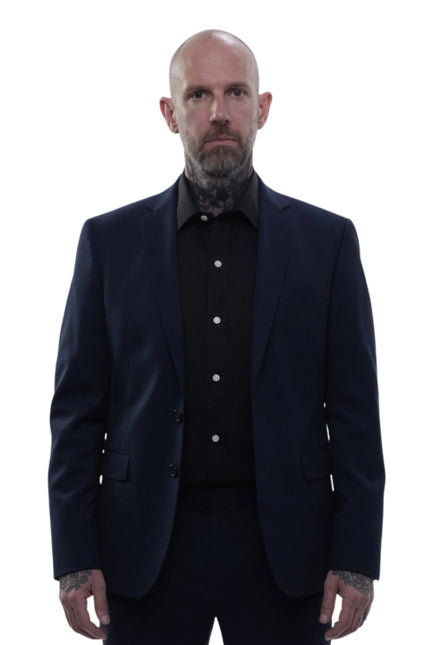 Man wearing a dark suit and shirt on a white background