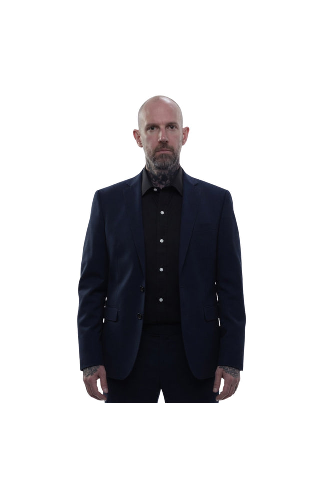 Man wearing a dark suit and shirt on a white background