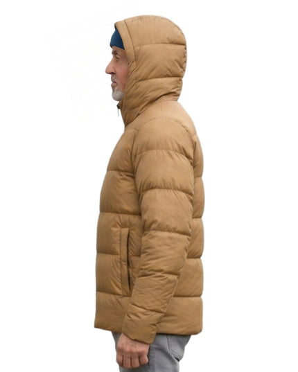 Person wearing a tan puffer jacket on a white background