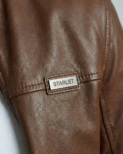 Brown leather jacket with 'STARLET' label on a light gray background