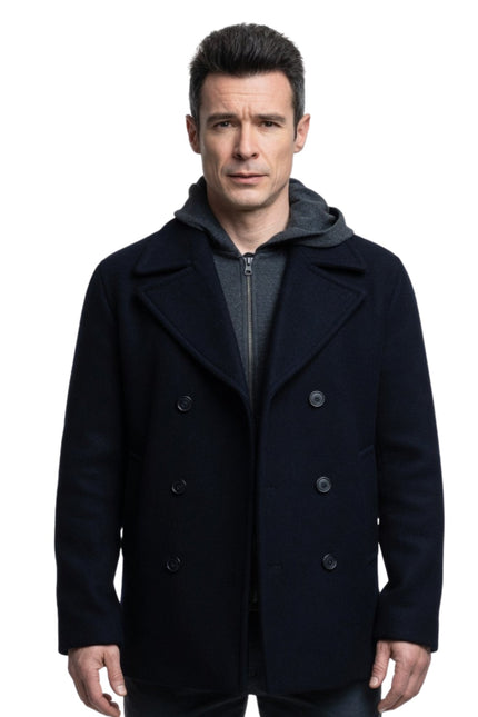 Man wearing a dark blue peacoat on a white background