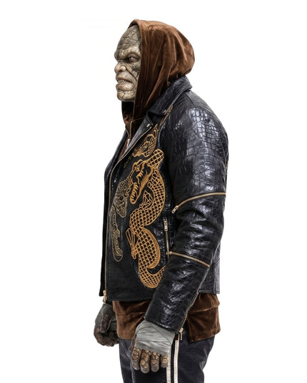 Person wearing a detailed leather jacket with a hood and dragon design on a white background