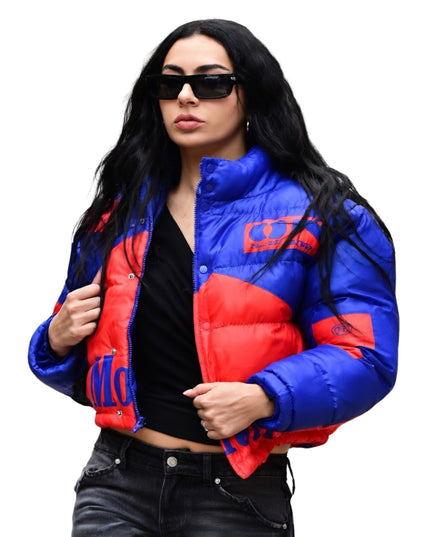 Woman wearing a blue and red puffer jacket on a white background