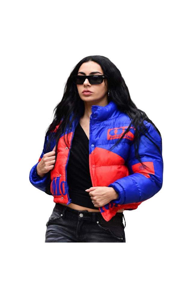 Woman wearing a blue and red puffer jacket on a white background