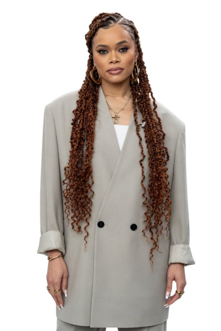 Woman wearing a light gray coat on a white background