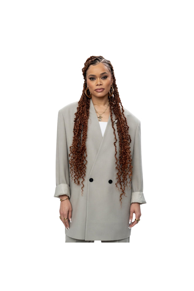 Woman wearing a light gray coat on a white background