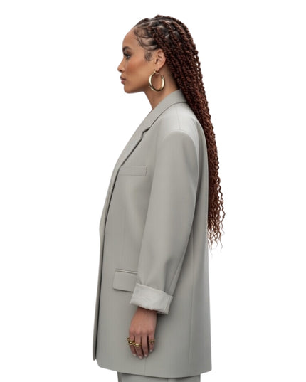 Woman wearing a light gray coat on a white background
