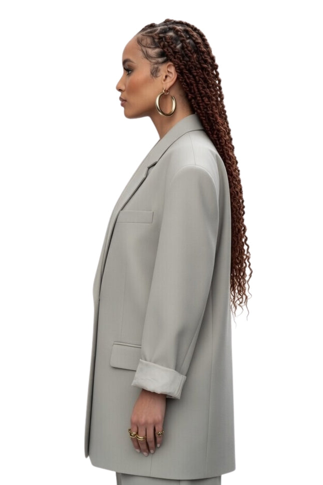Woman wearing a light gray coat on a white background