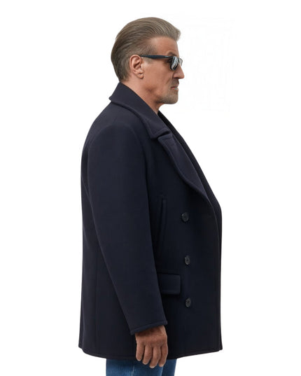 Man wearing a dark coat and sunglasses on a white background