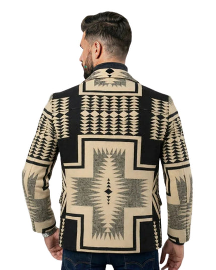 Man wearing a patterned jacket with geometric designs on a white background