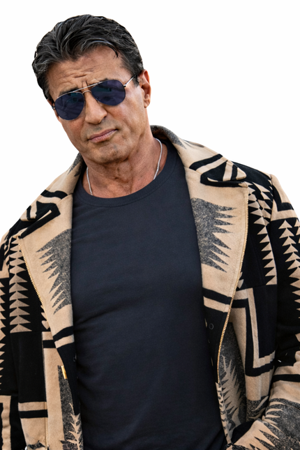 Man wearing a patterned cardigan over a dark shirt on a white background