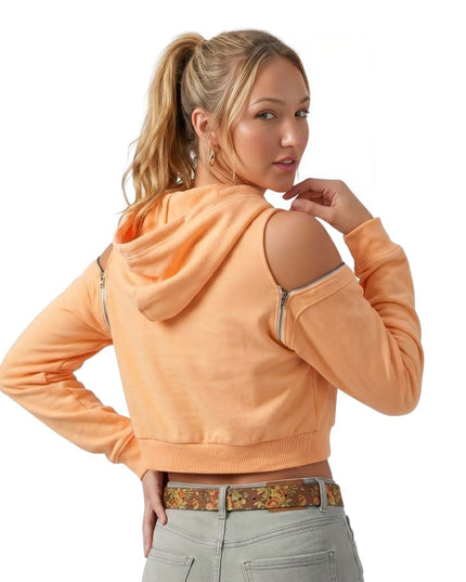 Woman wearing an orange hoodie with cut-out shoulders on a white background