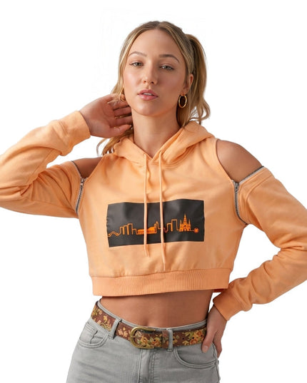 Woman wearing an orange hoodie with a graphic design on a white background