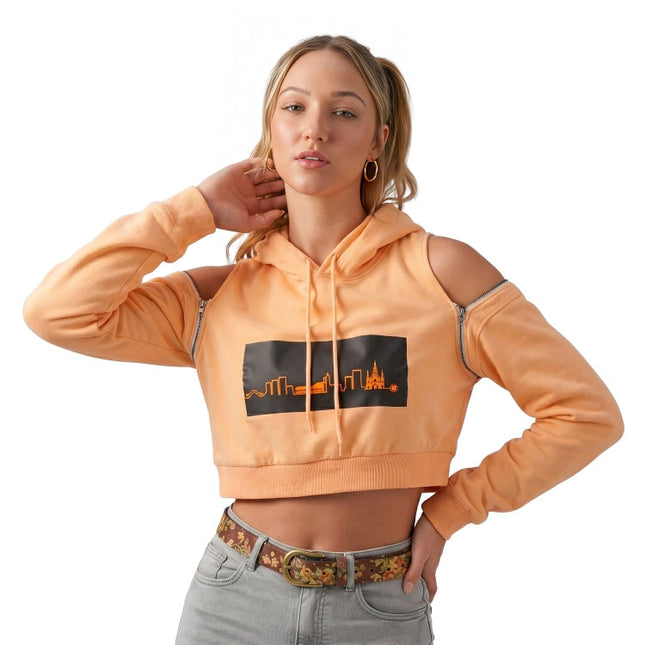 Woman wearing an orange hoodie with a graphic design on a white background