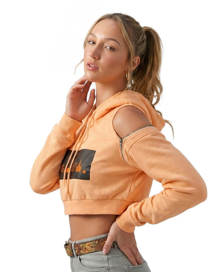 Woman wearing an orange hoodie with a logo on a white background