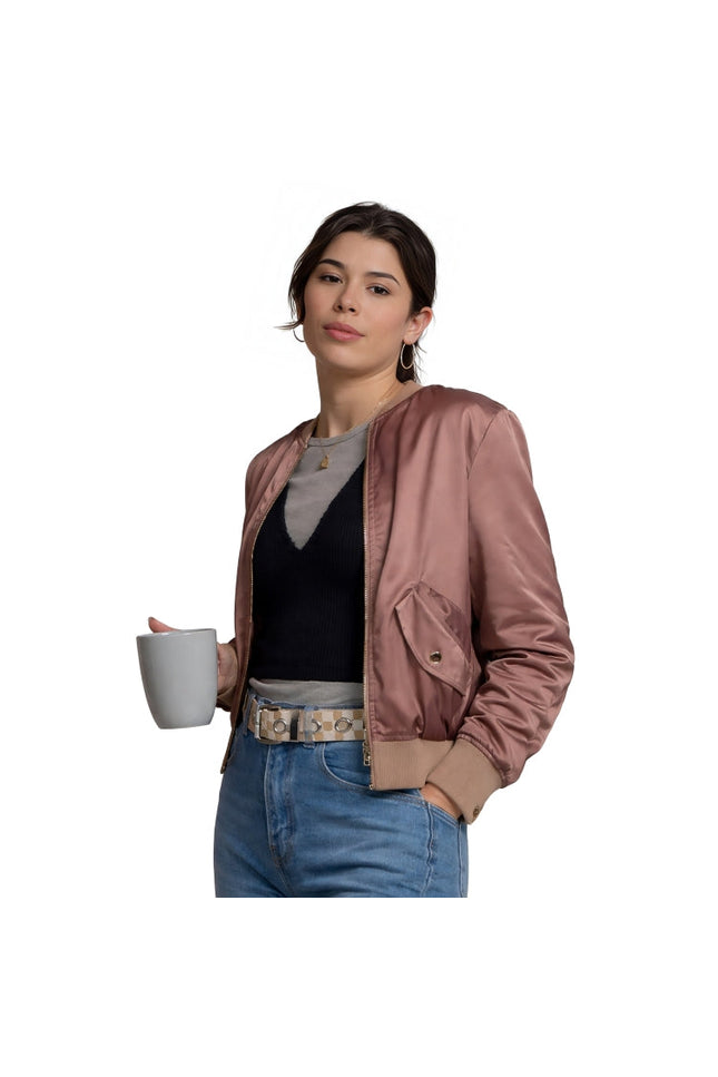 Woman holding a white mug wearing a pink jacket and blue jeans on a white background