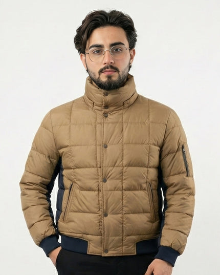Man wearing a beige puffer jacket on a white background