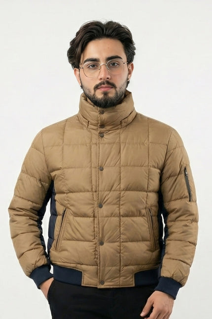 Man wearing a beige puffer jacket on a white background