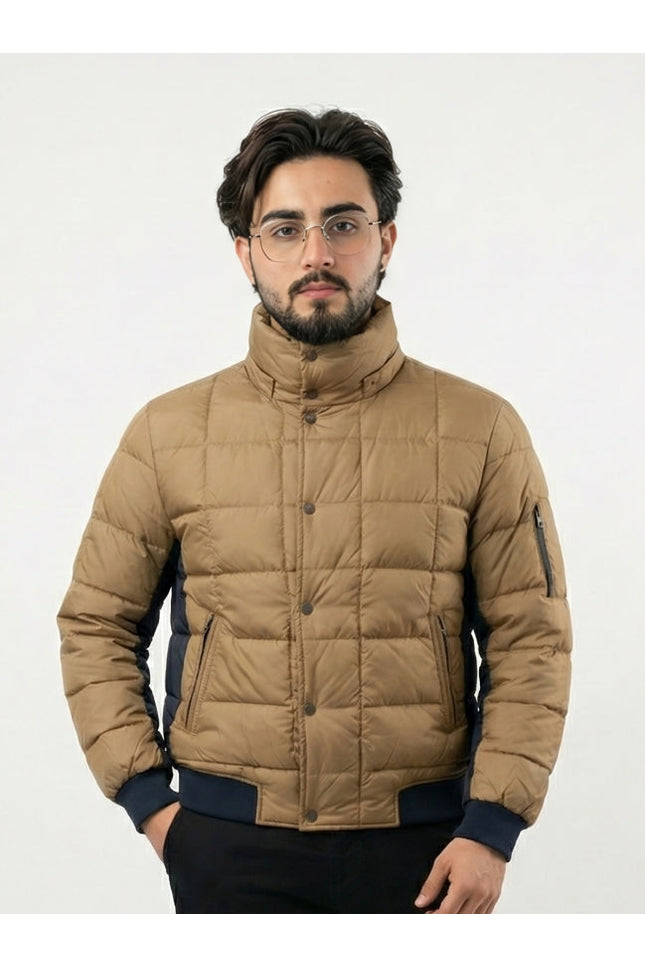 Man wearing a beige puffer jacket on a white background