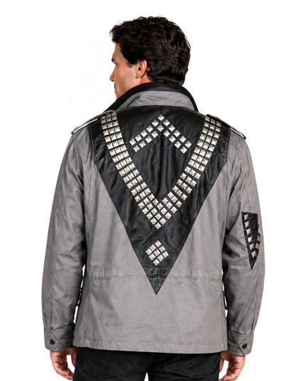 Man wearing a gray jacket with black geometric patterns on the back against a white background